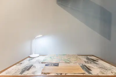 a table with a map and a lamp on it at Villa Up in Rome