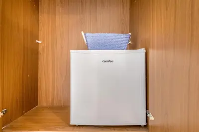 a white refrigerator with a chair on top of it at Villa Up in Rome