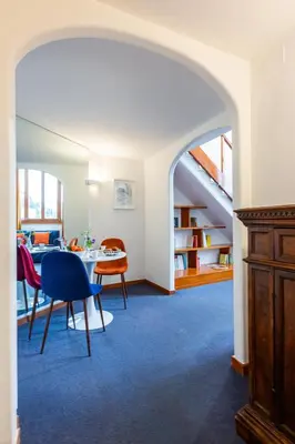 a living room with an archway and a table and chairs at Spanish Steps Luxury Apartment in Rome