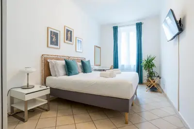 a bedroom with a bed and a television in it at Terrazza San Lorenzo - Luxury Apartment - Roma Centro in Rome