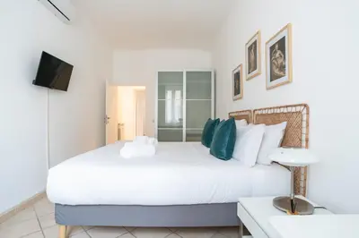 a bedroom with a large white bed and a tv at Terrazza San Lorenzo - Luxury Apartment - Roma Centro in Rome