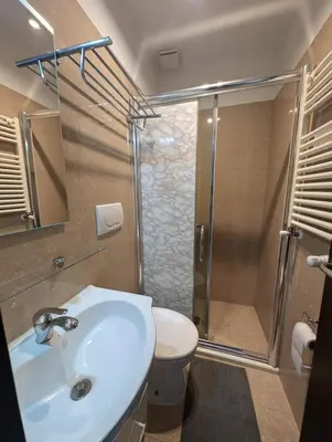 a bathroom with a shower and a sink and a toilet at Roomz Romestay in Rome