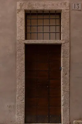 a wooden door on the side of a building at Apppartamenti Vicolo degli Osti in Rome