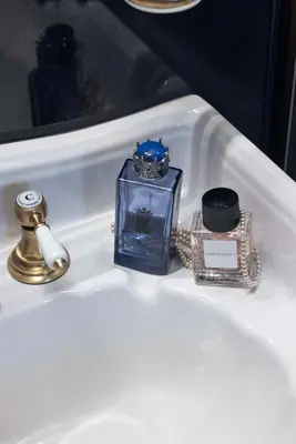a white sink with a bottle of perfume and a ring at Apppartamenti Vicolo degli Osti in Rome