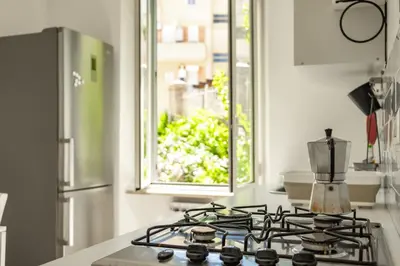 a kitchen with a stove top oven with a window at St Peter Clivo 1 by BuddyRent in Rome