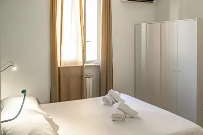 a bedroom with a bed with towels on it at St Peter Clivo 1 by BuddyRent in Rome