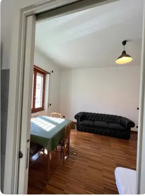 a living room with a table and a couch at Maison del Forte Boccea 108 in Rome