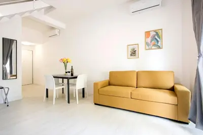 a living room with a couch and a table at Urban Oasis near Termini, free Parking&Patio, int3 in Rome