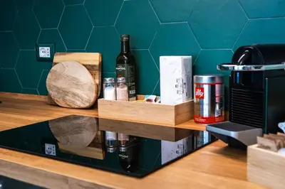 a shelf with bottles of wine and other items on it at Casa Fen Palazzo Storico - Re di Roma metro A - 2camere2bagni in Rome