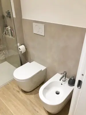 a bathroom with a white toilet and a sink at Casa di Corto in Rome