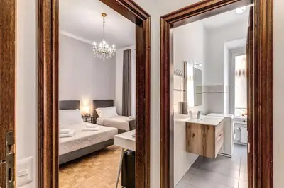 a living room with a couch and a sink and a mirror at Vatican Eagle Rooms in Rome