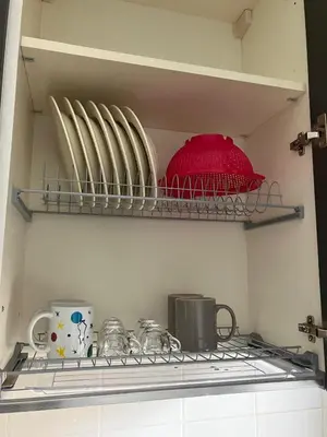 a shelf in a kitchen with dishes and utensils at FAIROME Apartment Albricci in Rome