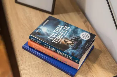 two books sitting on top of a table at SorinaHome Campo de Fiori Loft in Rome