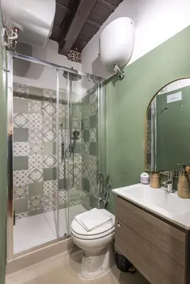 a bathroom with a shower and a toilet and a sink at SorinaHome Campo de Fiori Loft in Rome