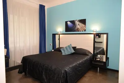 a bedroom with a bed in a blue room at Capital Suite in Rome