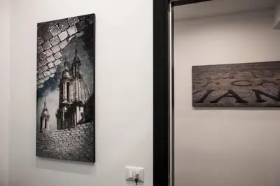 a picture hanging on a wall next to a painting at Capital Suite in Rome