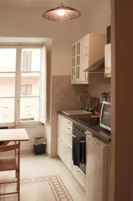 a kitchen with a sink and a stove top oven at Green House in San Lorenzo Termini in Rome