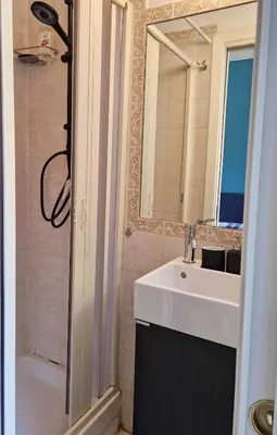 a bathroom with a sink and a shower with a mirror at Green House in San Lorenzo Termini in Rome