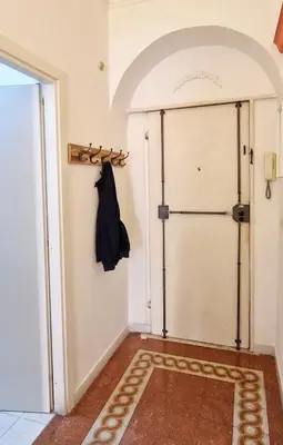 a room with a door and a coat rack at Green House in San Lorenzo Termini in Rome