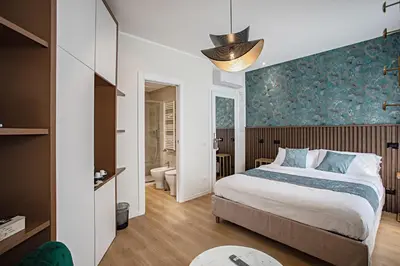 a bedroom with a bed and a blue wall at Rome suite Rome Vaticano Guest house in Rome