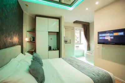 a bedroom with a bed and a tv and a tub at Rome suite Rome Vaticano Guest house in Rome