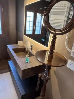 a bathroom with a sink and a mirror at Domus Colosseum, detached house just few steps from the Colosseum in Rome
