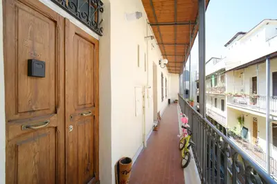 a hallway of a building with a bike parked next to a door at St Lawrence by BuddyRent in Rome