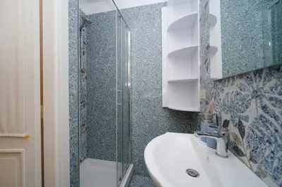 a bathroom with a sink and a shower at St Lawrence by BuddyRent in Rome