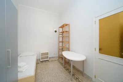 a small room with a white table and a shelf at St Lawrence by BuddyRent in Rome