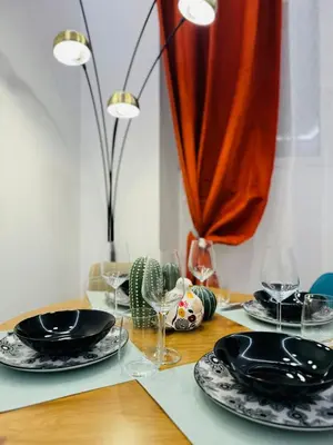 a wooden table with black plates and glasses on it at Friendly Apartment San Saba in Rome