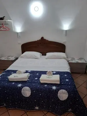 a bedroom with a bed with three towels on it at APARTAMENTo FANTI22 in Rome
