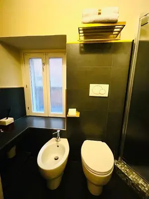 a bathroom with a toilet and a sink at TritHome in Rome
