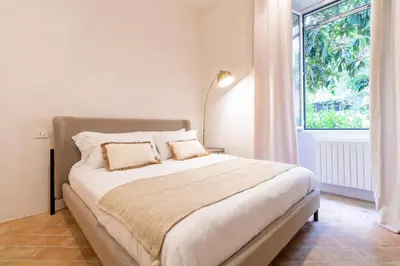 a bedroom with a large bed and a window at Cunabu Morosini in Rome