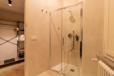 a shower with a glass door in a bathroom at Cunabu Morosini in Rome