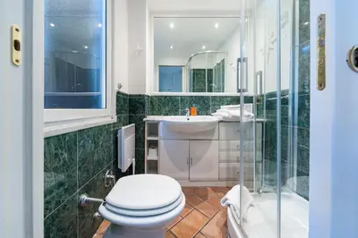 a bathroom with a toilet and a sink and a shower at Beautiful in Rome