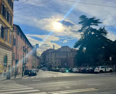 a city street with cars parked on the side of the road at Enjoy Colosseo in Rome