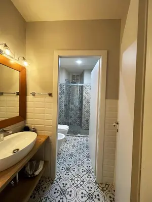 a bathroom with a sink and a toilet at Enjoy Colosseo in Rome