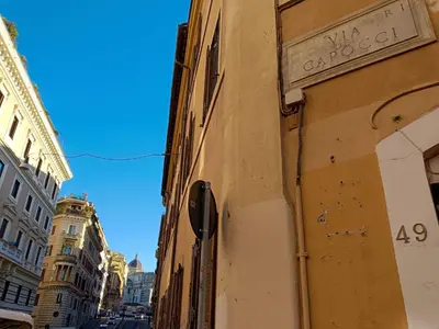 a building with a street sign on the side of it at Capocci by Halldis in Rome