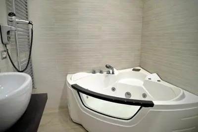 a white bathroom with a tub and a sink at Gregori Guest House in Rome