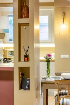a kitchen with a table with a vase of flowers at OldStation in Rome