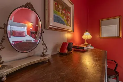 a room with a mirror and a table with a bed at OldStation in Rome