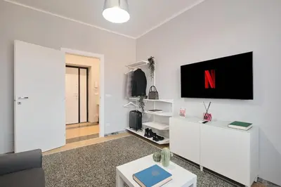 a living room with a tv on a white wall at Colosseo-San Giovanni, New Apartment Wi-Fi & A-C in Rome