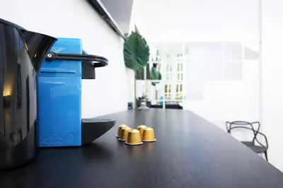 two gold shoes sitting on a table next to a printer at LUX- Spanish Steps 60A Exclusive Suite Apartment in Rome