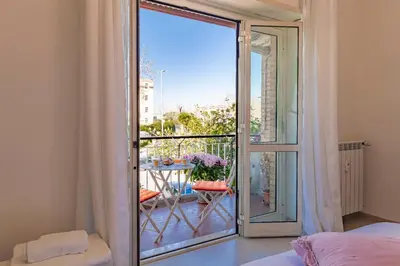 a bedroom with a sliding glass door to a balcony at Joy Home in Rome