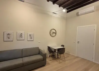 a living room with a couch and a table at Ripetta Views Luxury room and suite in Rome