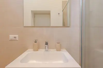 a bathroom with a white sink and a mirror at Ripetta Views Luxury room and suite in Rome