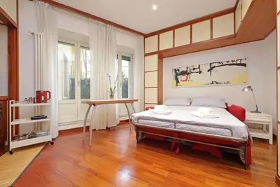 a bedroom with a bed and a table in it at Porta Metronia Suite in Rome