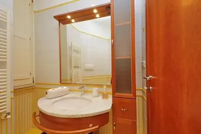 a bathroom with a sink and a mirror at Porta Metronia Suite in Rome
