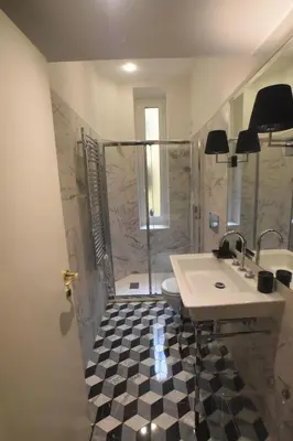 a bathroom with a shower and a sink and a toilet at Piano Suite in Vatican in Rome