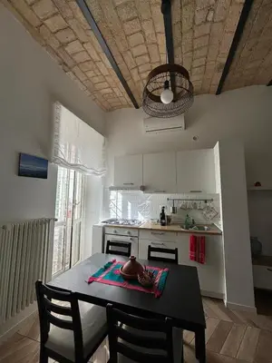 a kitchen with a table and chairs in a room at Casa Mari - Cozy Apartment San Paolo Rome in Rome